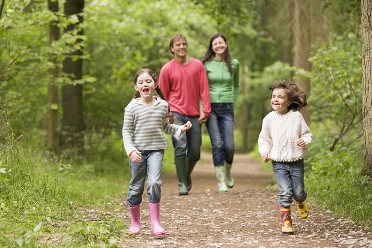 happy family hiking in woods